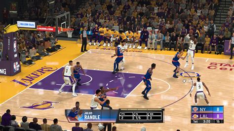 Is the basketball game on. Basketball is played by 2 teams with 5 players each. You score by putting the ball through the hoop. Dribble or pass to move the ball. Players are not allowed to take more than two steps after picking the ball up before shooting or passing it. Points scored inside of the round arc on the floor are worth 2 points. 