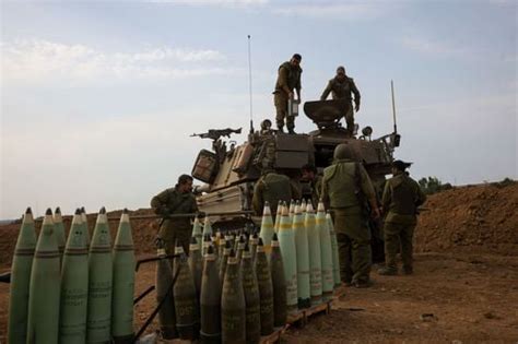 Israel bolsters troops at border with Gaza as Hamas hits Ashkelon with rocket barrage