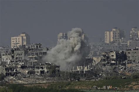 Israeli forces battle Hamas outside Gaza City, as airstrikes level apartments in refugee camp