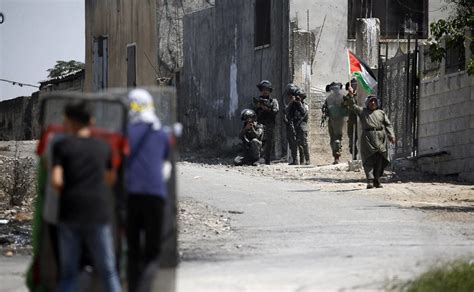 Israeli forces raid a West Bank town, sparking a firefight that kills a Palestinian teacher