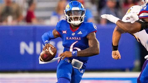 Kansas's Jason Bean (9) passes the ball to Mason Fairchild (89) during the second quarter of an NCAA college football game against Oklahoma State, in Stillwater, Okla., Saturday, Oct. 14, 2023 .... 