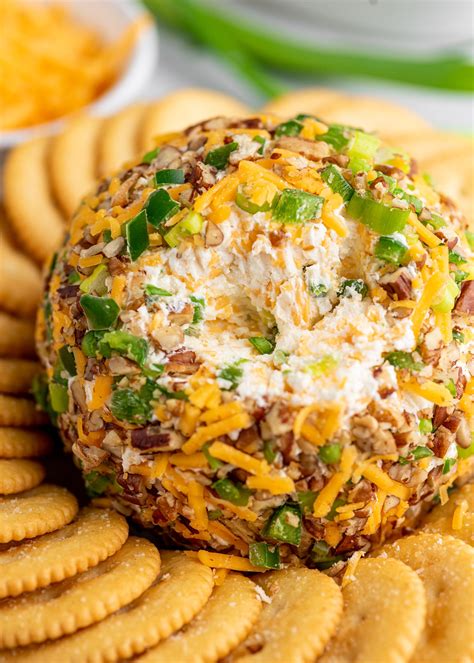 Jalapeno cheese ball. Fold in 1 1/2 cups shredded cheddar cheese, 1/4 cup chives, 1 cup bacon crumbles, and 1 cup diced jalapenos. Stir ingredients with a spoon until well combined. Wearing gloves roll cream cheese mixture into a ball and wrap with saran wrap. Store for an hour or overnight for the best texture and taste. 