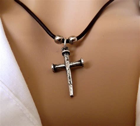 This mixed metal piece - the cross is bronze and the fish hook is sterling silver - is a masculine complement to the Fishers of Men Bracelet. CM-5799-465863. Specifications. Sterling Silver and bronze. 1 1/8 Inches Long x 11/16 Inches Wide.