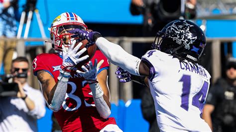 The Jayhawks drove down and made it a one-score game again, scoring a touchdown on a 28-yard pass from Jalon Daniels to Luke Grimm. The extra point made it a 28-21 lead for TCU with 9:23 left.. 