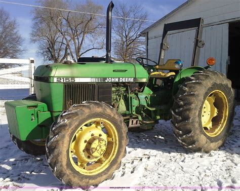 Buyer's premium included in price USD $325.00 John Deere 2155 MFWD, 540 pto, 6,806 hrs, 2 remotes, QH, counter weight box, new tie rods, #L02155F736419, with JD 175 loader, with quick tach bucket, HLA 78" bucket, pallet for bucket and bale spear sell separately. Owner bought a new tractor only.... 