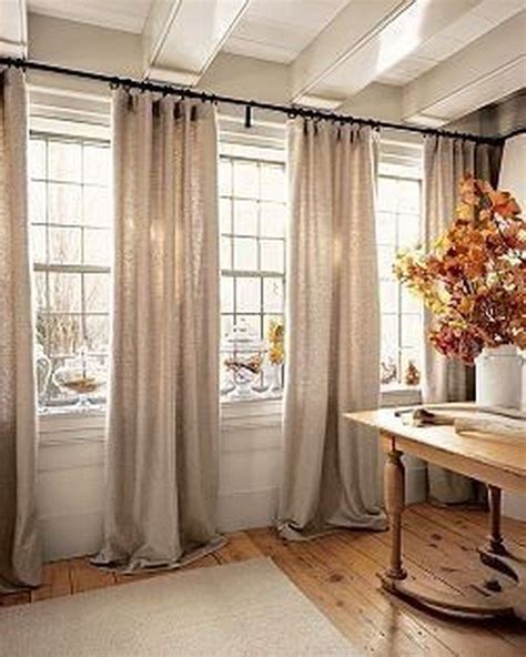 To create the illusion of higher ceilings, hang your curtain rod higher above the window. Typically about halfway from the top of your window to the ceiling is a good rule of thumb. I hung my curtains 11 inches from the top of the window. To create the illusion of a bigger room or bigger windows, hang your curtains wider.. 
