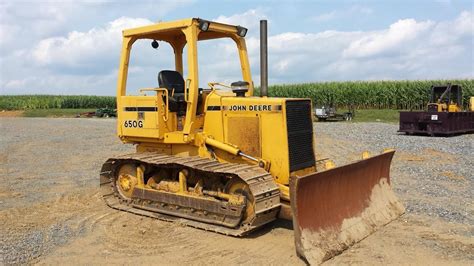 In this video, I buy a ~1970 john deere dozer 450 straight. Fix the steering clutches, and install a "canopy", and then push some dirt. 