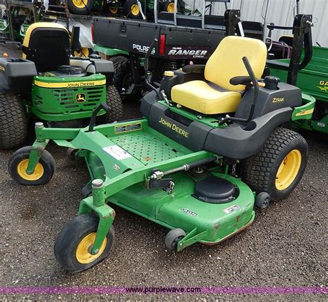 7. Add John Deere Low Viscosity HY-GARD™ (J20D) until oil level is at FULL mark on reservoir. 8. Install filter and cap. 9. Start engine. 10. Operate machine forward and in reverse several times. 11. Park machine safely on a level surface. (See Parking Safely in the SAFETY section.) 12. Wait at least 3 minutes for hydraulic oil to cool. 13.. 