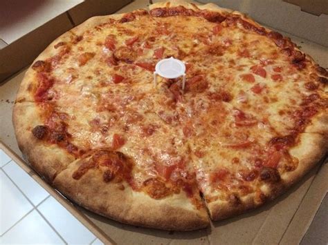 Johnny b's pizza. You hear pizza, you think cheese that flows like roof tar; pepperoni slices cupping in the oven, filling with grease; and a crust so overladen with toppings it droops like sorrow w... 