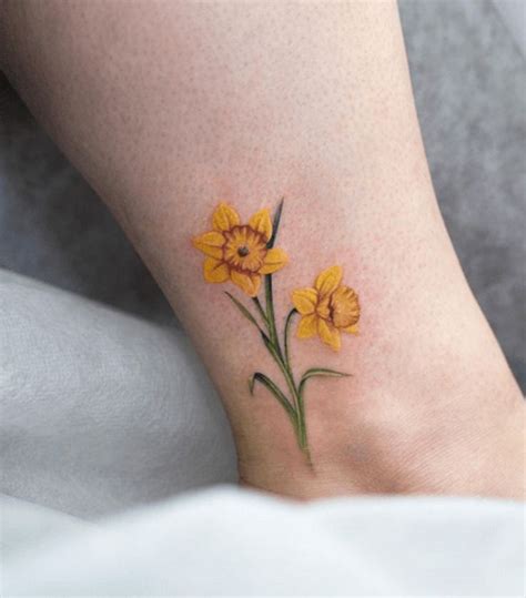 Jonquil flower tattoo. Jun 21, 2022 · Jonquils: Appearance. The jonquil flower is a small, delicate flower with short, reflexed petals and a long, slender stem. The flowers are typically yellow or white, although some varieties have been bred to produce pink or orange blooms. The jonquil has long, strap-like leaves and a cluster of small, yellow flowers at the tip of each stem. 