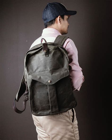 Journeyman backpack. Filson contrasted the Journeyman Backpack's classically outdoorsy exterior with modern features like a padded laptop sleeve. Its durable Tin Cloth twill fabric has an oil finish to shield your electronics from wet weather, and the padded shoulder straps have a tear-resistant moleskin lining for a smooth, sueded feel. 