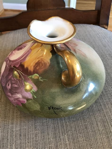 For Sale - Antique Porcelain & Pottery from Abigail's Antiques on Ruby Lane - This romantic Limoges Jean Pouyat France hand painted porcelain " courting couple" pillow vase, dated Dec 14, 1896. Signed by artist P. Smith. The enchanted couple are portrayed in pastel colors with gold gilt on handles and woven around the. 
