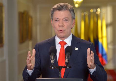 Colombia President Juan Manuel Santos smiles as he addresses reporters with his wife, first lady Maria Clemencia de Santos, after winning the Nobel Peace Prize, at Narino Palace in Bogota on Oct. 7.