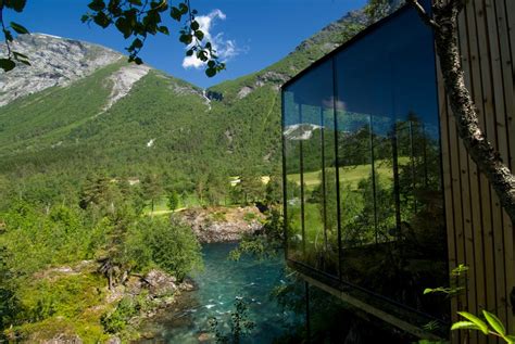 Juvet landscape hotel. Juvet Landscape Hotel – a synthesis of raw Norwegian nature, cultural history and modern architecture. The first landscape hotel in Europe is situated in the farmstead of Burtigarden farm at Alstad in Valldal, on a steep, natural levee amongst birch, aspen, pine and age-old boulders. 