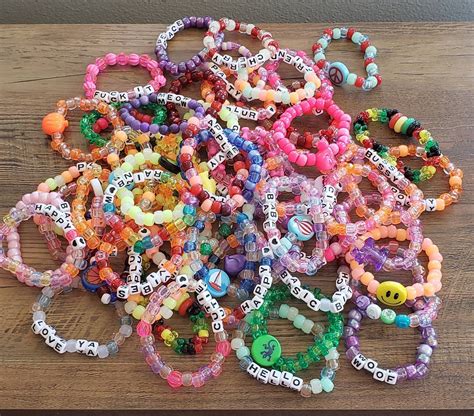 Kandi singles ideas. We love making kandi bracelet singles to trade at raves and festivals! It is so fun to come up with a cheeky unique phrase. Check out our list of over 200 ideas if you need help coming up with yours! #rave #festival #kandi 
