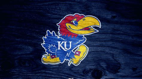 Kansas jayhawks background. The white color appeared on the Kansas Jayhawks visual identity in 1941. The bird, facing left, was refined and drawn with more details, having two white “KU” letters on its blue jersey. The beak of the Jayhawk was now a bit opened, creating a visual sense of smile and making the whole image friendly and welcoming. 1946 – 2006 