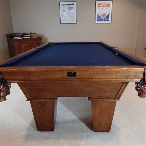 Kasson pool table. Could be a Kasson, or Brunswick but one things for sure, it's a furniture grade table. I had a similar Olhausen that I lost my ass big time when I sold it. Of course mine was a 8' not a Pro 8' (8-1/2') like it seems this one is. Only a few high end pool tables retain value good, this type isn't one of them. 