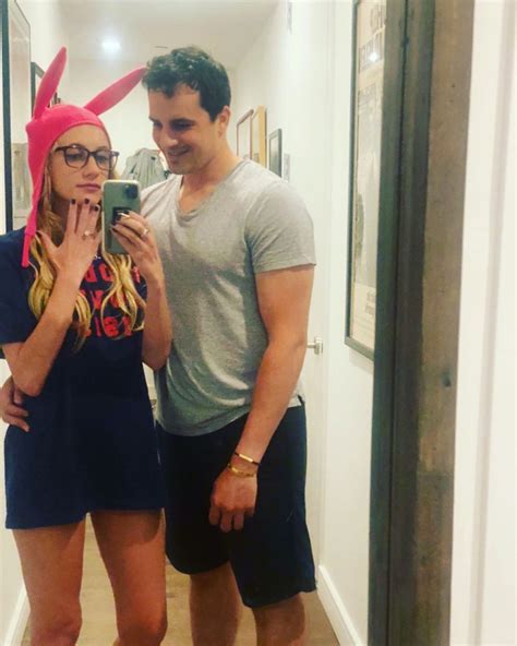 Days later, Timpf posted a candid photo of the pair and joked that their "engagement photos are HERE." The pic in question was a mirror selfie that featured Friscia wrapping his arm...