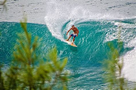 Kauai surfing. The summer is tranquil and tropical with small to flat surf. The north shore of Kauai is one of the rainiest places on Earth, which explains the lush waterfalls dotting the landscape. But like a ... 