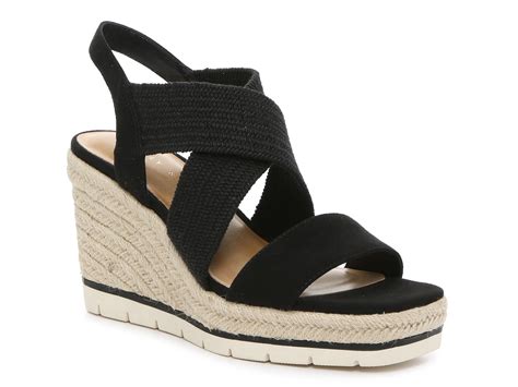 Kelly & Katie Gwennan Espadrille Wedge Sandal. The Gwennan wedge sandal from Kelly & Katie upgrades any warm weather look with its striped espadrille heel. The delicate two-piece upper and towering wedge are sure to make a stylish statement. Item # 524596; UPC # 190234759734. 
