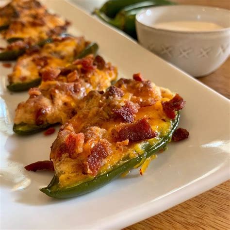 Keto jalapeno poppers. Season to taste with salt and pepper. Spoon the cream cheese filling into the jalapeños. Cut the bacon strips in half, and wrap 1 piece around each stuffed jalapeño half. Place the bacon-wrapped jalapeños, cut-side up, in a single layer in the air fryer basket. Cook for 10 to 15 minutes, until the bacon is crispy. 