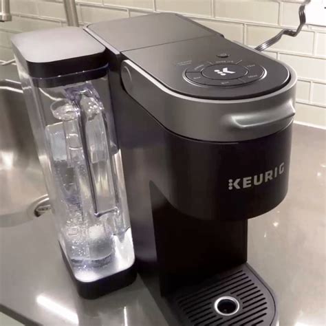 Place a large mug on the drip tray. To activate Descale Mode, begin with the brewer powered off, then press and hold the 8oz and 12oz buttons together for 3 seconds until the DESCALE light turns solid. When brew button begins flashing, press the brew button to start the cleansing rinse brew. Pour the hot liquid into the sink.. 