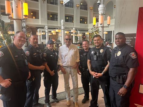 Kevin Costner snaps a photo with RTD police at Union Station