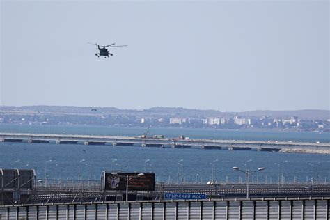 Key Russian bridge to Crimea is struck again, with Moscow blaming Ukraine for an attack that kills 2