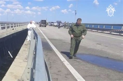Key Russian bridge to Crimea is struck again as Putin vows response to attack that killed 2