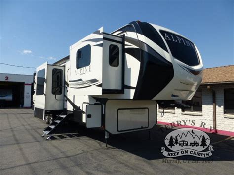 Keystone Alpine 3712KB. Make entertaining at the campground a breeze in the Keystone Alpine 3712KB fifth wheel, which provides a front living area that is perfect for watching the big game. You'll find that the five slide-outs give you plenty of elbow room inside this 41′ RV, and you'll love having the space to welcome your guests.. 