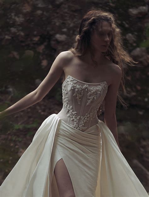 Kim kassas bridal. Astris. A modified mermaid dress featuring falling shoulder strap accents, a sheer panel deep-v neckline and high leg slit. This dress is made of Solstiss lace with intricately … 