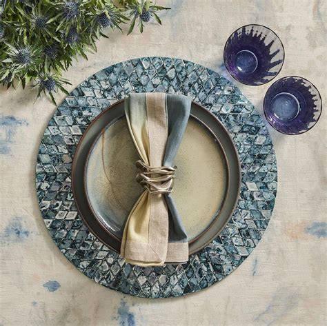 Kim seybert. Perfect for everyday dining or for a lavish dinner party, these placemats are easy to care for. Simply wipe down before storing. Details. COLOR: Elephant. DIMENSIONS: 15.5" Length x 15.5" Width x 0.75" Height. WEIGHT: 0.6 lbs. MATERIALS: 100% Polyurethane with PVC Backing. IMPORTED. 