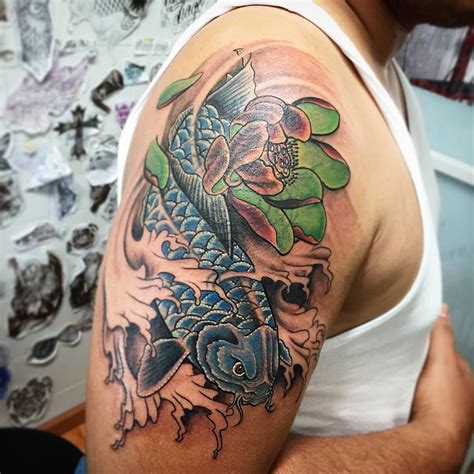Another colorful koi fish tattoo idea is the blue koi fish. Although this type of design is more popular with men, since blue is considered as a masculine color. Blue koi fish often represent reproduction. Apart from that, it could also stand for calmness and tranquility of the mind and body.. 
