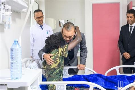 King of Morocco visits earthquake patients at Marrakech, kissing one on head and donating blood