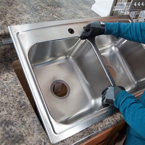 Kitchen sink installation. 2. Connect your sinks. As shown in the image below, use a connecting pipe to join up the plumbing. This should be above your P-trap and drain as all the water needs to flow down a single route. Connect the pipe between the kitchen sinks and secure it in place using a connector ring, nuts, and bolts. 3. 