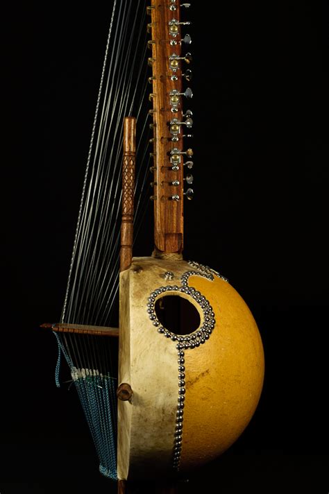 Kora instrument. The kora is a 21-string instrument originating from Western Africa.Resembling both a harp and a lute, this unique instrument has a gourd-like resonator box covered in animal hide that sits below a long hardwood neck. The player can either sit or stand to play a range of notes stretching over three octaves. 