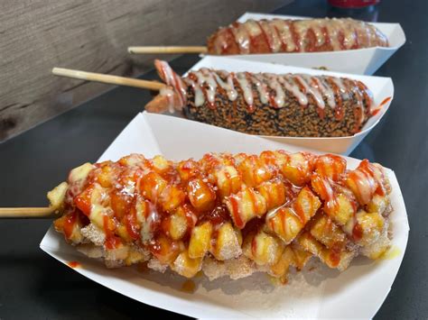 Add egg and milk and mix until combined. Pour the mixture into a tall glass. Dredge each corn dog skewer into the mixture and immediately place it into the panko. Coat all sides of the hot dog with panko. Fry for 4 minutes, 2 minutes on each side, until golden brown, and serve topped with mustard, ketchup, and ranch dressing.. 