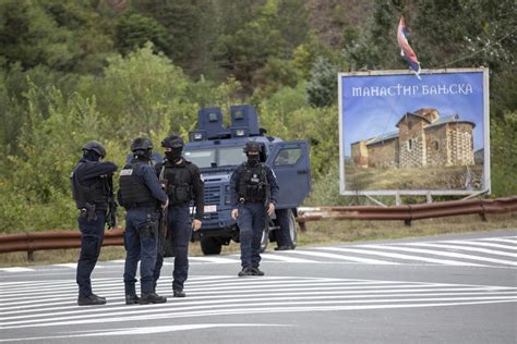 Kosovo mourns a slain police officer, some Serb gunmen remain at large after a siege at a monastery
