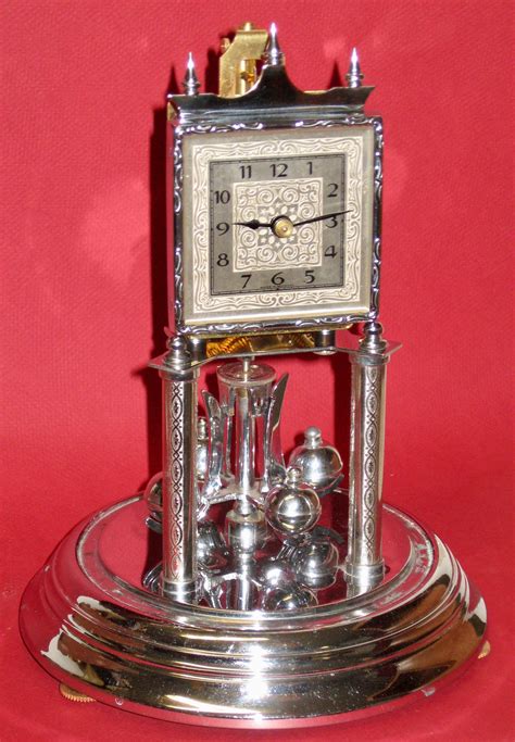 an estate is a vintage 1950's (after 1945 - 1965) 400 day Anniversary clock produced by Kieninger and Obergfell also known as "Kundo" Made in Germany. This is a key wind mechanical... Obergfell, Western Germany, 9" h including dome Estimate $50-100... Obergfell, Germany, 11 1/2" h including dome Estimate $100-150.... 