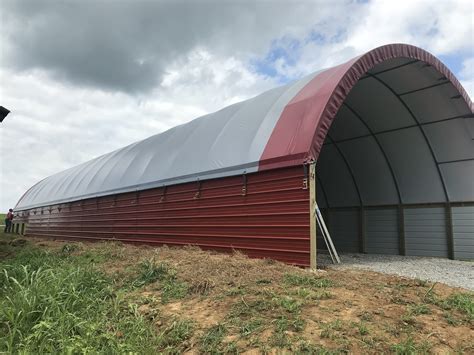 Ky hoop barns. Hoop barns are made of a durable steel frame covered with tensioned fabric. The steel frame typically consists of a single or double truss system, which accounts for its structural support. The fabric covering, often made from a tightly woven, UV-resistant material, shields the interior from direct exposure to rain, snow, and sunlight. ... 