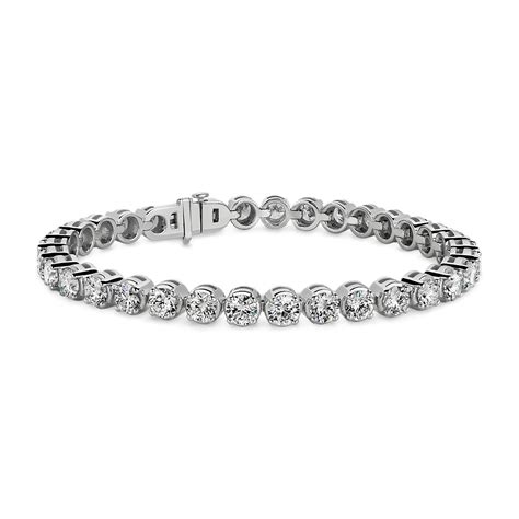 Lab grown diamond bracelet. Crafted in 10k white gold, this tennis bracelet features a glistening line of lab grown diamonds in classic four-prong settings. This timeless design will become a staple favorite! The lab grown diamonds are 5ctw, F in color, and SI2 in clarity. Bracelet measures 7.25 inches in length. REEDS exclusive ECONIC Diamonds are lab grown in a ... 
