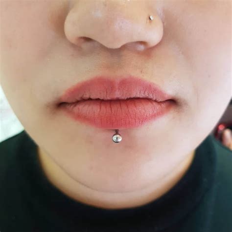 Labret lip ring. Labret piercing is a type of facial piercing located just below the center of the lower lip. Lip rings or studs with a flat back, known as labret studs, are commonly used for this type of piercing. … 