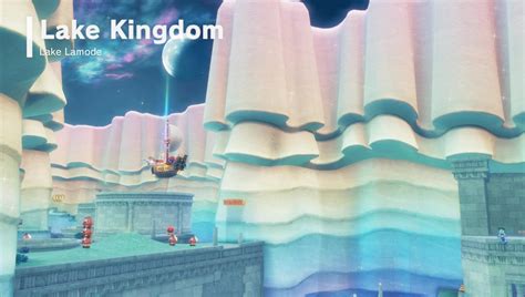 Donk City is full of Power Moons, and for good reason; they power the city. Head up to the New Donk City Hall, look southwest and the triangle-shaped building in view will have a hint art located on the side of it, quite close to the top. This art shows Poochy sniffing a glowing spot in the Lake Kingdom.. This spot is close to the pillars located at …. 