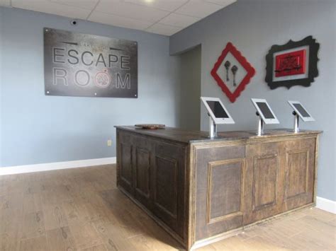 Lakeland escape room. The escape room is located in the Herring Building at 308 E Pine St, Lakeland, FL.. The facility is a brown brick building with beige borders. Arches at the entrance give the building a vintage look, and the brand name printed on the door invites you to the venue. 