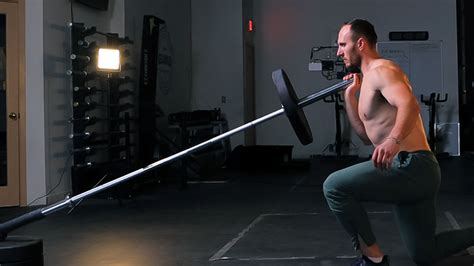 Landmine barbell exercises.  These exercises, performed using a barbell anchored at...