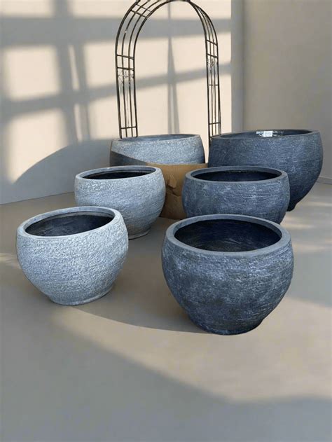 Large round fiberglass planters.  1.  large&prime;ness, n.  Durable fiberglass, 24 st...