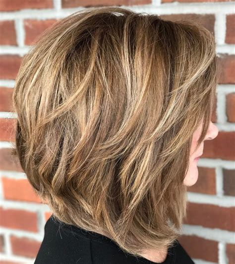 Medium Length Hairstyles for Women Over 50: Layered Bob with Curtain Bangs. The layered bob is clearly the trend hairstyle of 2022. It creates more volume, frames the face and, in combination with curtain bangs, can conceal one or two forehead wrinkles. In addition, the chin to shoulder-length bob is the perfect transitional hairstyle.. 