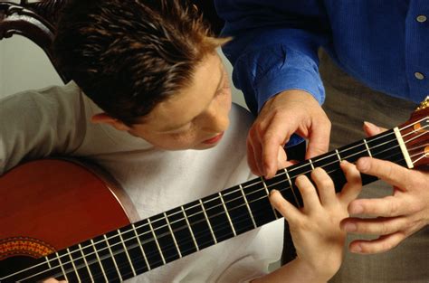 Learning guitar. Put the pick on the pad of your thumb and then come down on it with you index finger. Try to stay relaxed. Many newer guitarists have trouble holding on to the pick when strumming. If that is the case you can always try holding on to the pick with your thumb and first and second fingers. 