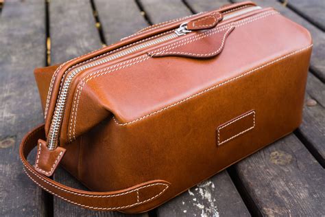 Leather dopp kit. Travel with all your bathroom essentials in our handmade leather dopp kit bag. 100% Handmade in Turkey Product: Handmade Leather Classic Dopp Kit & Travel Toiletry Bag Color/Finish: Crazy Horse Tan/DistressedDistressed tan-brown color showing under-tones of brown, caramel and walnut. Ages and softens quicker compared to regular leather. 