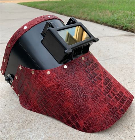 Leather welding mask. The AH5040-BK Split Cowhide Wrap-Around Helmet Bib by Black Stallion features durable split cowhide leather with wrap around coverage blocks more sparks, heat, & UV rays. The extended front coverage provides extra protection and reduces chest glare. Push on clips provide secure hold on most welding helmets. 